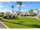 Beautiful property with a well-manicured front yard, lush grass, mature landscaping, and elegant architectural details at 6700 E Caron Dr, Paradise Valley, AZ 85253