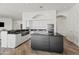 Well-appointed kitchen features an island, stainless appliances, black countertops, and ample cabinet space at 6700 E Caron Dr, Paradise Valley, AZ 85253
