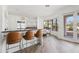 Spacious kitchen with stainless steel appliances, white cabinets, and a breakfast bar overlooking the backyard at 6700 E Caron Dr, Paradise Valley, AZ 85253