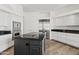 Modern kitchen boasts stainless steel appliances, a center island, and plentiful storage in white cabinets at 6700 E Caron Dr, Paradise Valley, AZ 85253