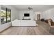 Spacious living room with hardwood floors, a large window, and a modern ceiling fan at 6700 E Caron Dr, Paradise Valley, AZ 85253