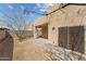 Desert landscaped backyard with covered patio and block wall in a neutral color at 701 Dylan Ct, Wickenburg, AZ 85390