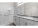 Modern bathroom with a double sink vanity, granite countertops, and tiled shower with a built in niche at 701 Dylan Ct, Wickenburg, AZ 85390