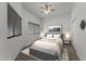 Cozy bedroom with a comfortable bed, soft lighting, and a large window offering natural light at 701 Dylan Ct, Wickenburg, AZ 85390