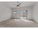 Bedroom with carpet, a ceiling fan and natural light coming from the sliding glass door at 701 Dylan Ct, Wickenburg, AZ 85390