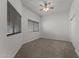 Carpeted bedroom with modern ceiling fan and large window with wood blinds at 701 Dylan Ct, Wickenburg, AZ 85390