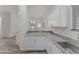 Kitchen featuring granite countertops, stainless steel sink, and white cabinetry at 701 Dylan Ct, Wickenburg, AZ 85390