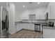 Bright modern kitchen featuring stainless steel appliances, granite countertops, and bright white cabinetry at 701 Dylan Ct, Wickenburg, AZ 85390