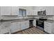 Well-lit kitchen featuring stainless steel appliances, granite countertops, and bright white cabinetry at 701 Dylan Ct, Wickenburg, AZ 85390