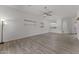 Bright, open-concept living room features wood floors and a large window at 701 Dylan Ct, Wickenburg, AZ 85390