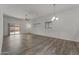 Spacious open living area with modern floors and contemporary lighting fixtures at 701 Dylan Ct, Wickenburg, AZ 85390