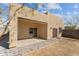 Covered patio featuring desert landscaping, block wall, and adjacent outdoor space at 701 Dylan Ct, Wickenburg, AZ 85390