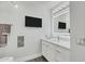 Sleek bathroom with an illuminated mirror, floating vanity, and modern TV at 7151 E Rancho Vista Dr # 1003, Scottsdale, AZ 85251