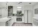 Bright kitchen with white cabinets, stainless steel appliances, a backsplash and a large island and sink at 7151 E Rancho Vista Dr # 1003, Scottsdale, AZ 85251