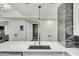 This kitchen features a large island with a sink and a view into the hall with doors and the bathroom at 7151 E Rancho Vista Dr # 1003, Scottsdale, AZ 85251