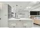 A kitchen with stainless appliances flows to the living room with seating, a fireplace and large television at 7151 E Rancho Vista Dr # 1003, Scottsdale, AZ 85251