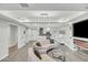 Bright living room featuring modern lighting, fireplace, television and an open floorplan flowing into the kitchen at 7151 E Rancho Vista Dr # 1003, Scottsdale, AZ 85251