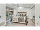 Bright main bedroom featuring wood floors, a ceiling fan, a modern desk and outdoor view at 7151 E Rancho Vista Dr # 1003, Scottsdale, AZ 85251