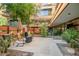 Relaxing patio area with umbrella coverage and stylish outdoor furniture at 7151 E Rancho Vista Dr # 1003, Scottsdale, AZ 85251