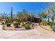 Desert landscaping with native plants and a stone walkway leading to the entrance at 7411 E Quien Sabe Way, Scottsdale, AZ 85266