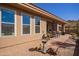 View of the covered patio with outdoor dining and seating area, and desert landscaping at 7411 E Quien Sabe Way, Scottsdale, AZ 85266