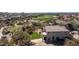Aerial view of the backyard with a grassy area and desert landscape along with the surrounding neighborhood and golf course at 7424 E Sandia Cir, Mesa, AZ 85207