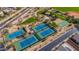 Community aerial showcasing tennis courts, basketball court, playground, and green spaces at 7424 E Sandia Cir, Mesa, AZ 85207