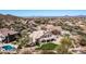 An aerial view of the home showing the manicured backyard, pool in the neighbor's yard, and desert mountain backdrop at 7424 E Sandia Cir, Mesa, AZ 85207