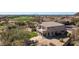 Aerial view of the home, showcasing the manicured landscaping, backyard and community at 7424 E Sandia Cir, Mesa, AZ 85207