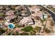 A birdseye shot of the landscaped yard, pool next door, and desert landscaping on the property at 7424 E Sandia Cir, Mesa, AZ 85207