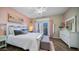 Bright bedroom with a white bed frame, access to balcony, and modern decor accents at 7424 E Sandia Cir, Mesa, AZ 85207
