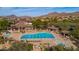Stunning community pool area with a large swimming pool, lounge chairs, and mountain views at 7424 E Sandia Cir, Mesa, AZ 85207