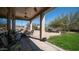 Covered patio with a dining table and chairs, offering views of the backyard at 7424 E Sandia Cir, Mesa, AZ 85207