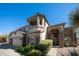 Beautiful two-story home featuring a desert-style design and covered balcony at 7424 E Sandia Cir, Mesa, AZ 85207