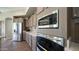 Modern kitchen with stainless steel appliances, stone countertops, and built-in microwave and oven at 7424 E Sandia Cir, Mesa, AZ 85207