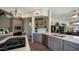 Contemporary kitchen with island cooktop, stone countertops, and stainless steel appliances at 7424 E Sandia Cir, Mesa, AZ 85207