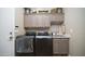 Laundry room with side-by-side washer and dryer and built-in cabinets and utility sink at 7424 E Sandia Cir, Mesa, AZ 85207