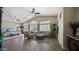 Open plan living and bedroom with vaulted ceilings, plantation shutters, and wood flooring at 7424 E Sandia Cir, Mesa, AZ 85207