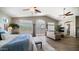 Open plan living and bedroom with vaulted ceilings, plantation shutters, and wood flooring at 7424 E Sandia Cir, Mesa, AZ 85207