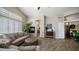 This elegant living room features wood-look floors, a fireplace, plantation shutters, and arched doorways at 7424 E Sandia Cir, Mesa, AZ 85207