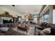 Open concept living room with a stone fireplace and large windows at 7424 E Sandia Cir, Mesa, AZ 85207