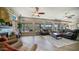 Spacious living room with a stone fireplace, wood floors, large windows, and comfortable seating at 7424 E Sandia Cir, Mesa, AZ 85207