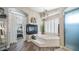 The main bathroom has a luxurious tub, fireplace, and neutral tones, creating a relaxing spa-like retreat at 7424 E Sandia Cir, Mesa, AZ 85207