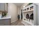 Hallway featuring a built-in hall tree with coat hooks, storage, cabinets and access to laundry room at 7424 E Sandia Cir, Mesa, AZ 85207