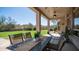 Relaxing covered patio area with outdoor dining table and chairs overlooking the backyard at 7424 E Sandia Cir, Mesa, AZ 85207