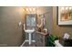 Stylish powder room featuring a pedestal sink, decorative mirror, and unique wall texture at 7424 E Sandia Cir, Mesa, AZ 85207