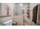The shower features stylish stone-look tile, a built-in bench, and a shower caddy for added convenience at 7424 E Sandia Cir, Mesa, AZ 85207
