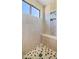 The shower features elegant stone-look tile, a built-in bench, and a convenient shelving niche for toiletries at 7424 E Sandia Cir, Mesa, AZ 85207