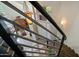 Staircase featuring metal railings, and views to entry, living spaces, and exterior windows at 7424 E Sandia Cir, Mesa, AZ 85207