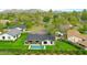 Stunning aerial view of a modern home featuring a pool and lush green landscaping at 7801 N 4Th Pl, Phoenix, AZ 85020